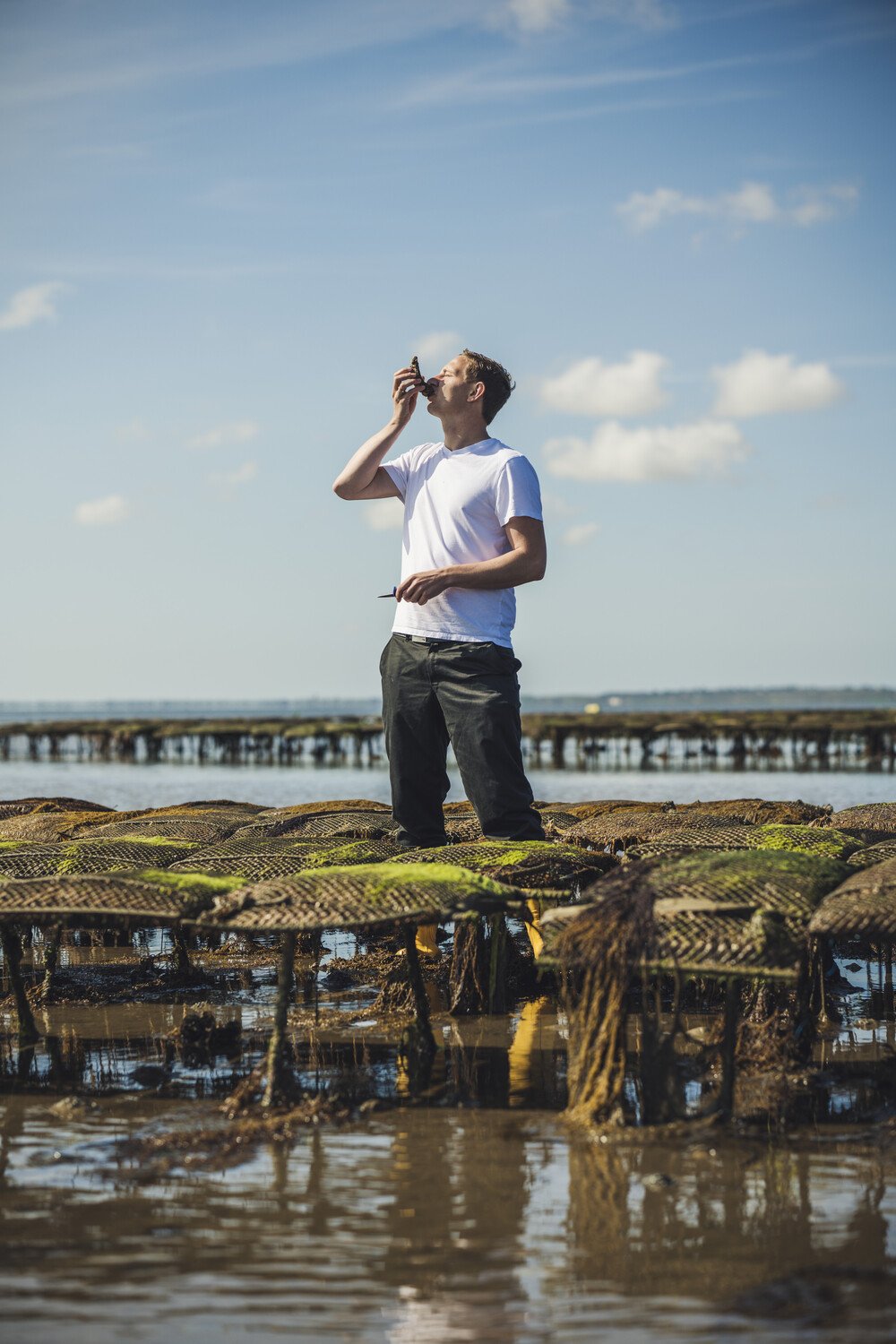 Man tasting an oyster at Söl’ring Hof, Sylt holiday destination.