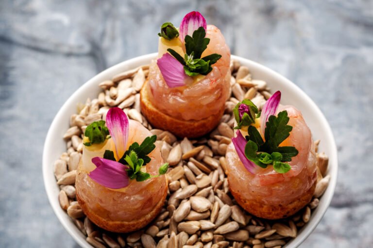 Seafood appetizers with flowers at Söl’ring Hof, Sylt holiday destination.
