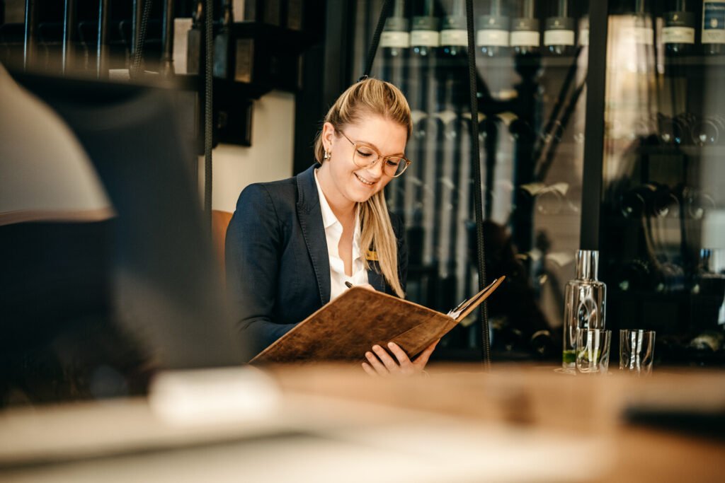 Staff member taking orders at Söl’ring Hof holiday destination, Sylt.