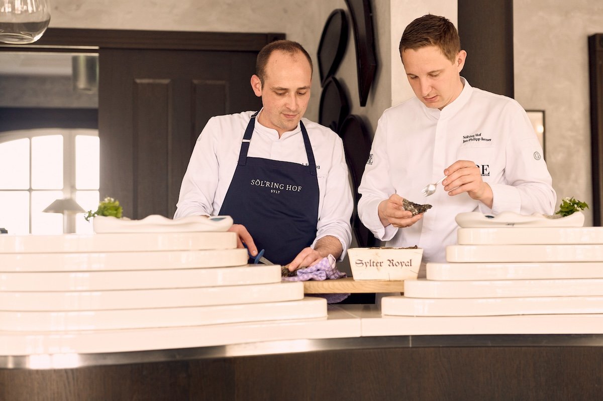 Zwei Köche bereiten Austern im Urlaubsort Söl’ring Hof auf Sylt zu.